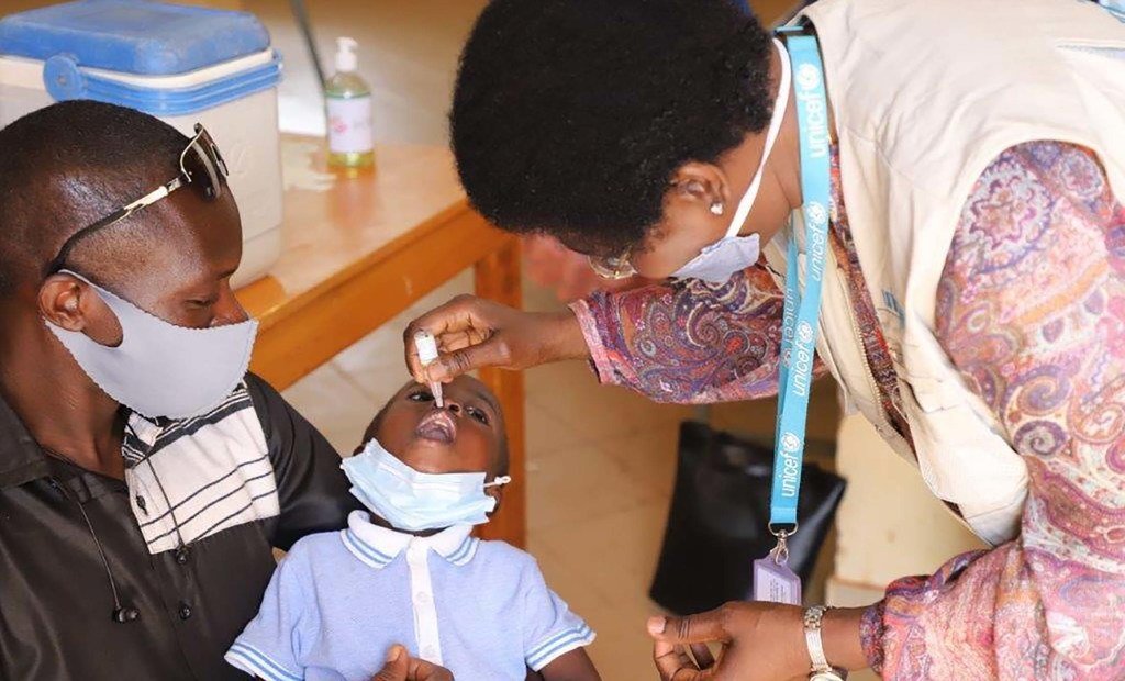 health worker administering polio vaccine in Burkina Faso