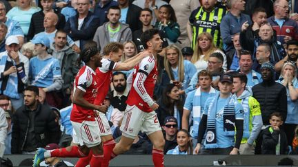 Noni Madueke, Martin Odegaard and Kai Havertz celebrate a goal against Manchester City on April 19, 2026