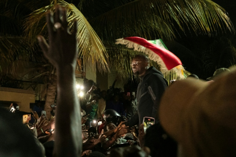 Supporters of former Senegalese Prime Minister Ousmane Sonko gather outside his Dakar home on May 23, 2026