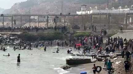 Migrants arriving on the coast of Ceuta after swimming past the Morocco-Spain border fence on July 30, 2026