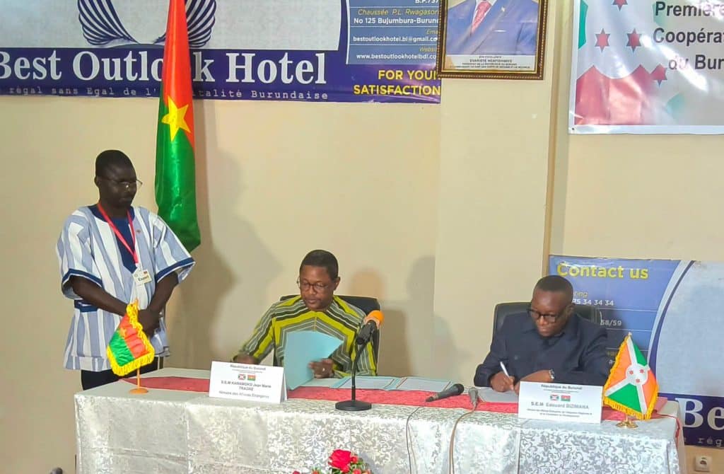 Officials from Burkina Faso and Burundi shaking hands during the signing ceremony
